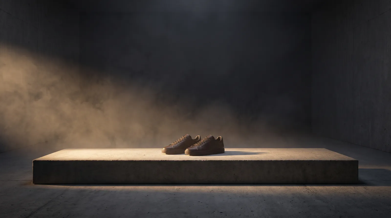 Men's sneakers styled in a dark concrete studio
